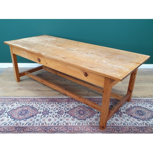 21 - A large Pine Kitchen Table on square supports and twin stretchers, 7ft Long x 3ft Wide x 2ft 6