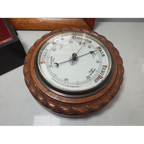 224 - A circular aneroid Barometer, a mahogany Box and cover and  an Oriental embroidery on silk, figures ... 