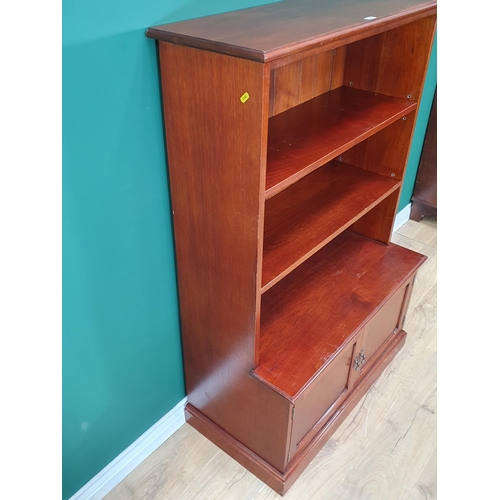 282 - A modern mahogany open Bookcase fitted two adjustable shelves above pair of panelled doors on plinth... 