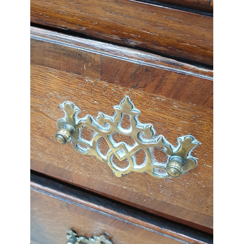 35 - An antique oak Bureau, the fall front with fitted interior above two short, three long drawers on br... 