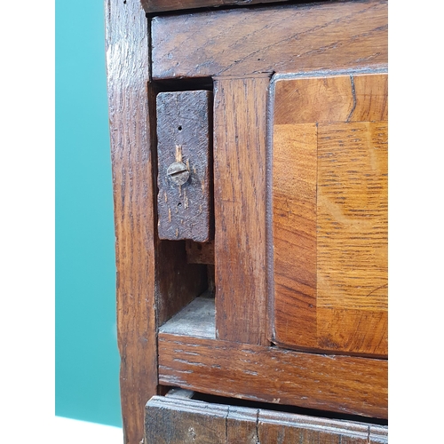 35 - An antique oak Bureau, the fall front with fitted interior above two short, three long drawers on br... 