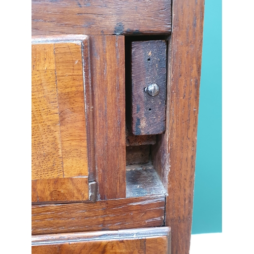 35 - An antique oak Bureau, the fall front with fitted interior above two short, three long drawers on br... 