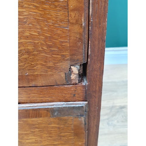 35 - An antique oak Bureau, the fall front with fitted interior above two short, three long drawers on br... 