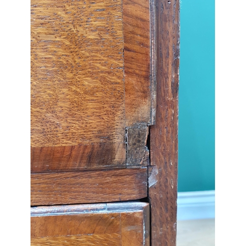 35 - An antique oak Bureau, the fall front with fitted interior above two short, three long drawers on br... 