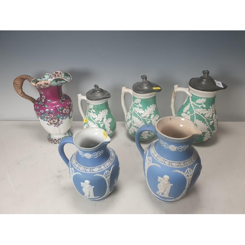 378 - A trio of green pottery Jugs with pewter lids decorated with oak leaves, and two Wedgewood style blu... 