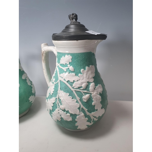 378 - A trio of green pottery Jugs with pewter lids decorated with oak leaves, and two Wedgewood style blu... 