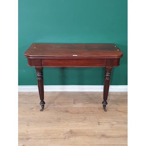 460 - A 19th Century mahogany Fold over Tea Table on turned and fluted tapered supports and castors, 2ft 6... 