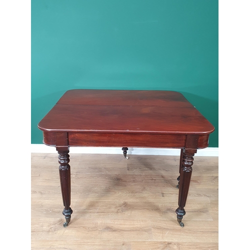 460 - A 19th Century mahogany Fold over Tea Table on turned and fluted tapered supports and castors, 2ft 6... 