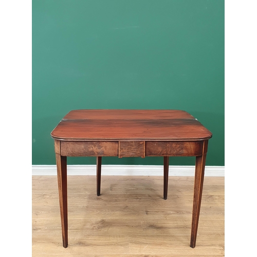 475 - A 19th Century mahogany Fold over Tea Table with satinwood stringing, on square tapered supports, A/... 