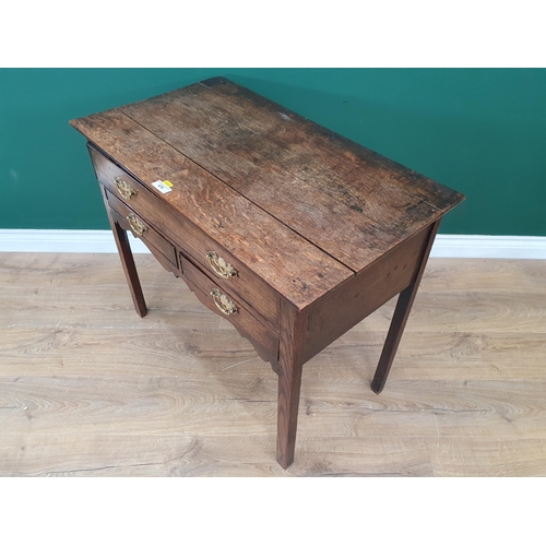 476 - An oak Lowboy fitted single drawer above two short drawers, with shaped frieze on square cut chamfer... 