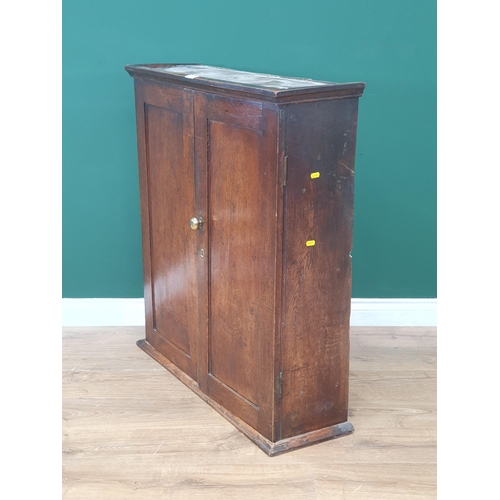 479 - An antique oak Cupboard with pair of panelled doors enclosing three shelves and two fitted drawers, ... 