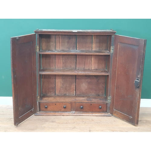 479 - An antique oak Cupboard with pair of panelled doors enclosing three shelves and two fitted drawers, ... 