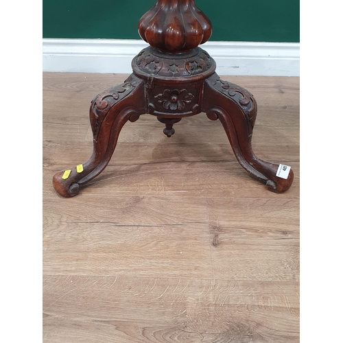 485 - A walnut adjustable Piano Stool with circular leather top on carved and fluted supports, A/F, 1ft 9