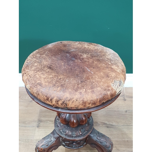 485 - A walnut adjustable Piano Stool with circular leather top on carved and fluted supports, A/F, 1ft 9