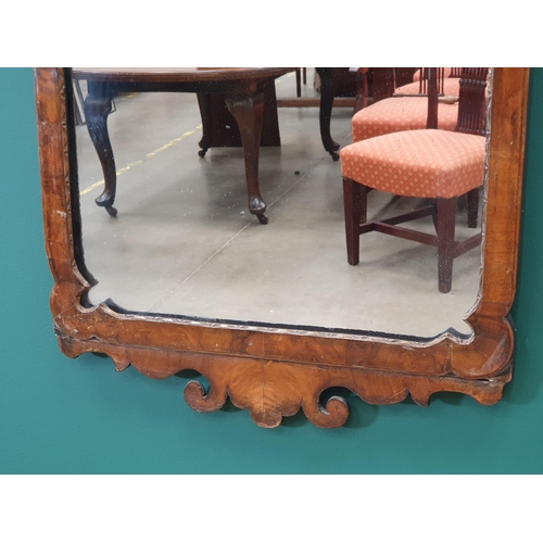 5 - A Georgian style walnut fret carved Wall Mirror, with scrolled surmount, 2ft 4