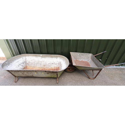 502 - A galvanised Tin Bath, 4ft 11in, and a Wheelbarrow