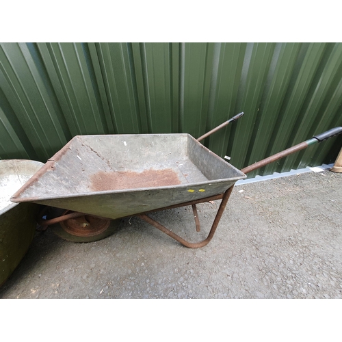 502 - A galvanised Tin Bath, 4ft 11in, and a Wheelbarrow