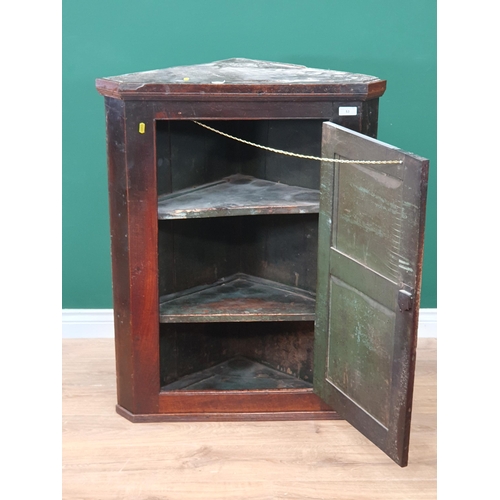 53 - An antique oak hanging Corner Cupboard with single panelled door enclosing shelves, 3ft 2in H