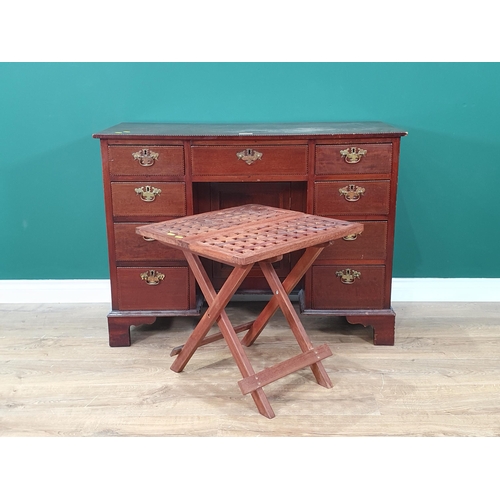 56 - A mahogany and crossbanded Kneehole Desk fitted nine drawers and single cupboard door on bracket fee... 