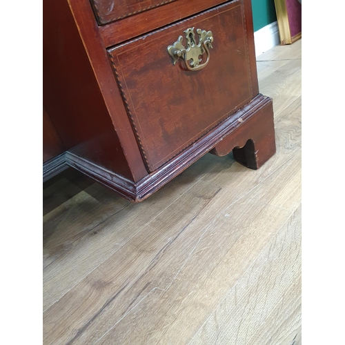 56 - A mahogany and crossbanded Kneehole Desk fitted nine drawers and single cupboard door on bracket fee... 