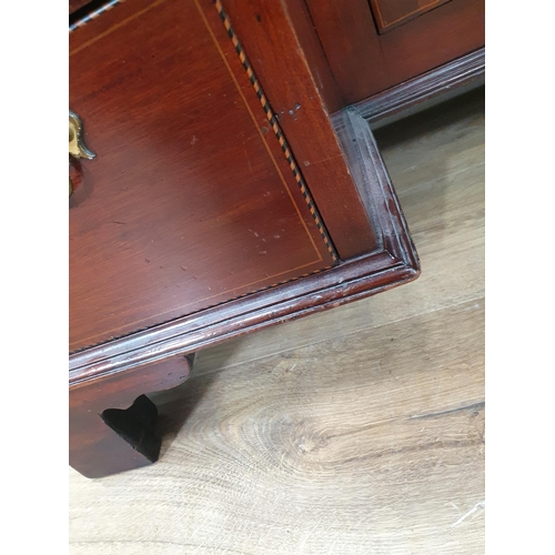 56 - A mahogany and crossbanded Kneehole Desk fitted nine drawers and single cupboard door on bracket fee... 