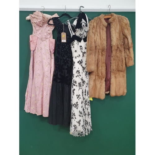 599 - A 1940's black long flared Dress, A/F, a fur Coat, 1940's boned bodice long pink satin Dress and a 1... 