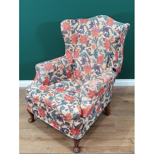 62 - A floral upholstered Wing Back Armchair on cabriole supports.