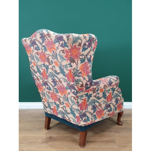 62 - A floral upholstered Wing Back Armchair on cabriole supports.