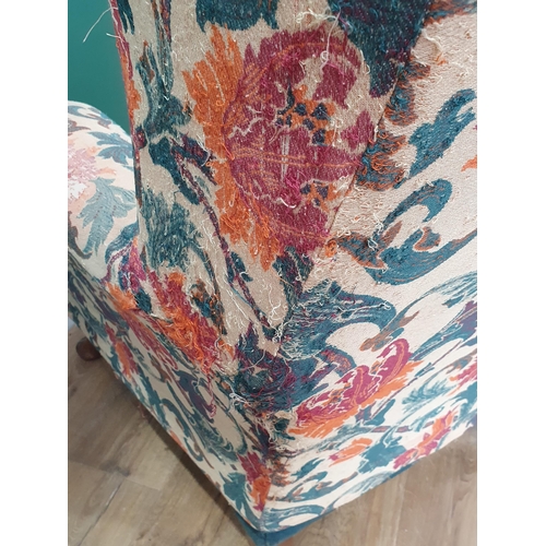 62 - A floral upholstered Wing Back Armchair on cabriole supports.