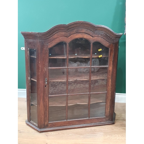 64 - An oak Dutch Style glazed Hanging Wall Cupboard 2ft 9