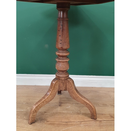 73 - An oak rectangular tilt top Tripod Table on turned support, 2ft 4