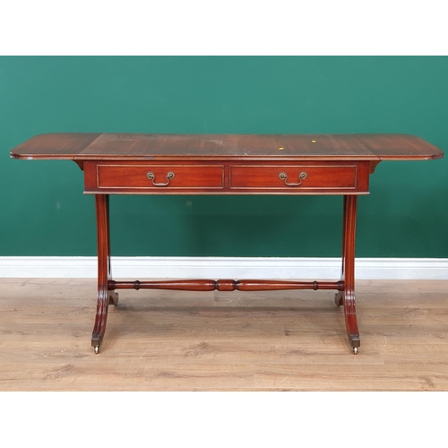 82 - A reproduction mahogany Sofa Table fitted two drawers, on shaped supports, turned stretcher and cast... 