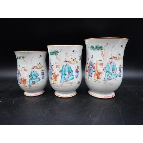 91 - A Set of three Chinese polychrome graduated bell shape Mugs painted figures and flowers in bright en... 