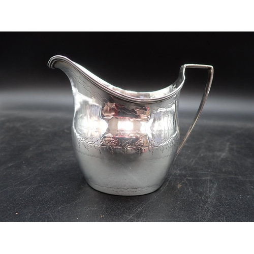 124 - A George III silver oval Jug engraved leafage frieze, reeded rim, London 1804