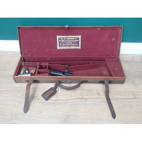 1104 - A canvas and leather trimmed hard Gun Case bearing W.W. Greener label with maroon baise lined interi... 