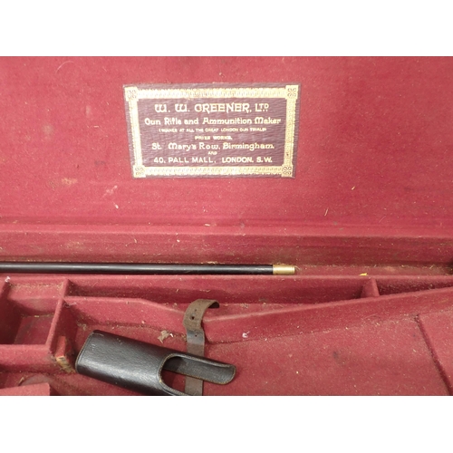 1104 - A canvas and leather trimmed hard Gun Case bearing W.W. Greener label with maroon baise lined interi... 