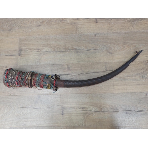 1132 - An African antelope horn and carved Ceremonial Horn with beadwork decoration 2ft 9in L