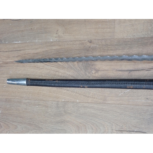 1170 - A replica of a Rapier with open guard and waved blade in leather scabbard 3ft 3in overall