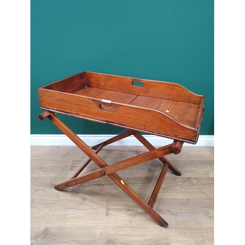 552 - A 19th Century mahogany Butlers Tray on folding stand.