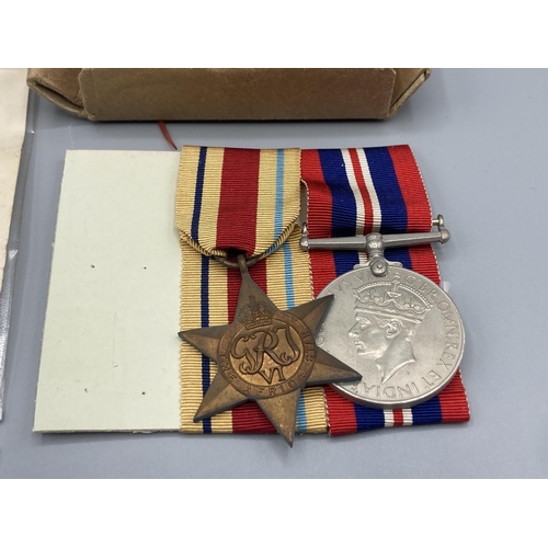 1058 - Three; WWII trio including War Medal, 1939-45 Star and Africa Star, with box of issue and condolence... 