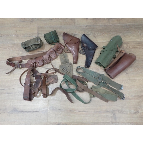 1102 - A leather Sam Brown, two leather Britiash Army type leather Pistol Holsters, a leather Ammunition Be... 