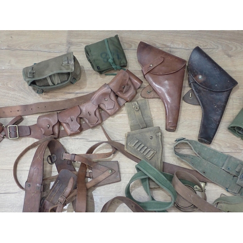 1102 - A leather Sam Brown, two leather Britiash Army type leather Pistol Holsters, a leather Ammunition Be... 