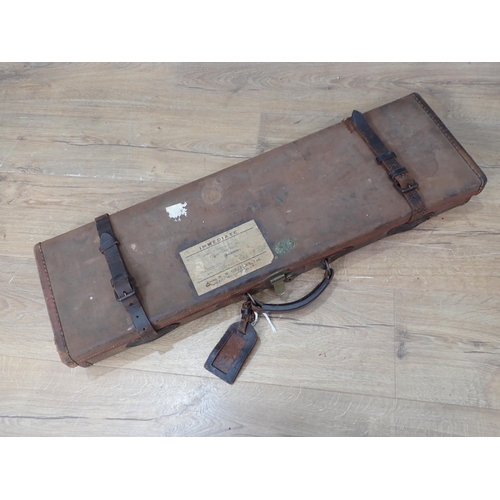 1104 - A canvas and leather trimmed hard Gun Case bearing W.W. Greener label with maroon baise lined interi... 