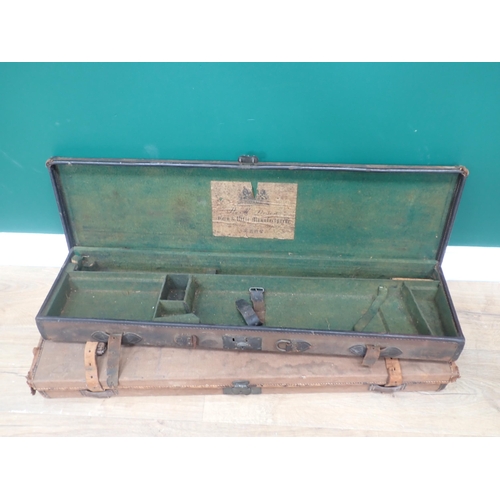 1107 - A canvas covered hard Gun Case bearing Army and Navy label for 30in barrels, another with W.R. Leeso... 