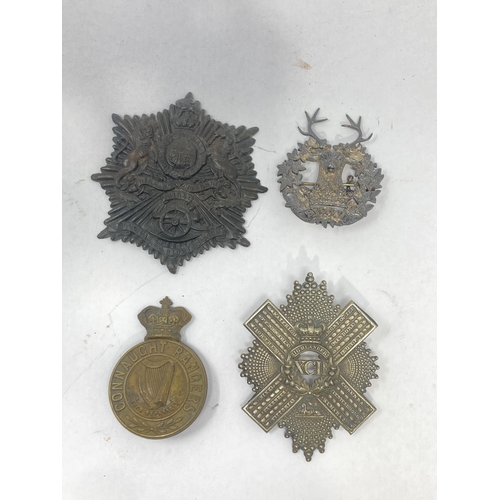 1114 - Four Cap Badges including Gordon Highlanders, Connaught Rangers, XCII Highlanders and Royal Artiller... 