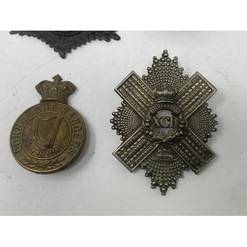 1114 - Four Cap Badges including Gordon Highlanders, Connaught Rangers, XCII Highlanders and Royal Artiller... 