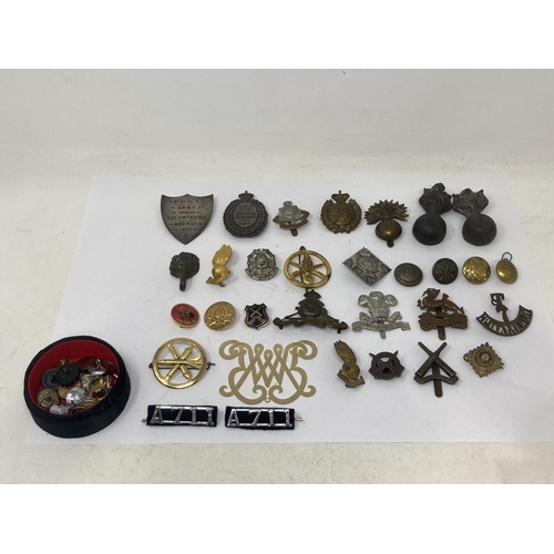 1116 - A box of Military and Police Cap Badges, Buttons and other Badges including 1899 Queen's Prize Posit... 