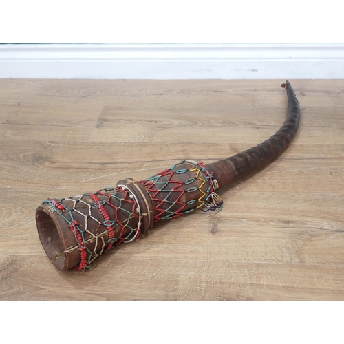 1132 - An African antelope horn and carved Ceremonial Horn with beadwork decoration 2ft 9in L