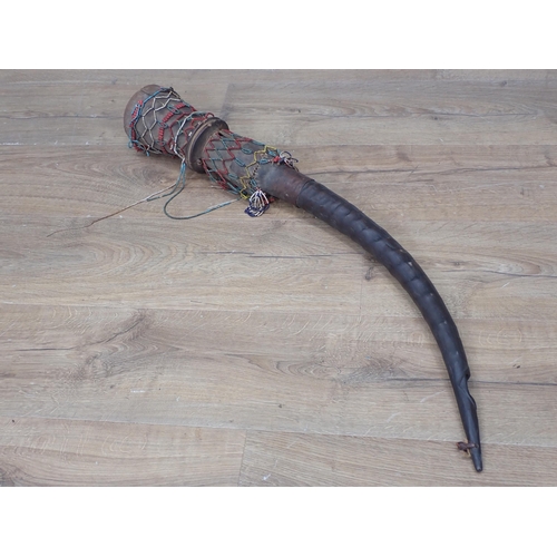 1132 - An African antelope horn and carved Ceremonial Horn with beadwork decoration 2ft 9in L