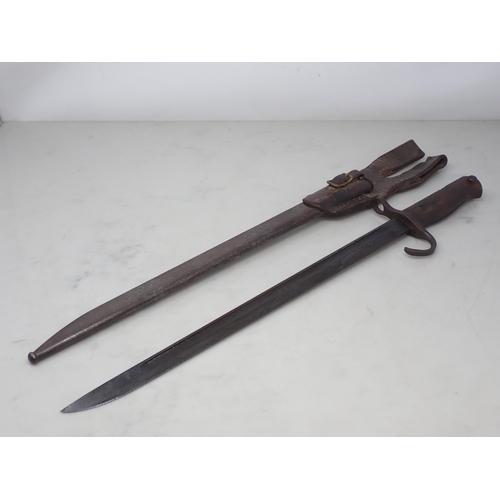 1143 - A Japanese type 30 Arisaka Bayonet is steel scabbard with leather frog 21in L overall